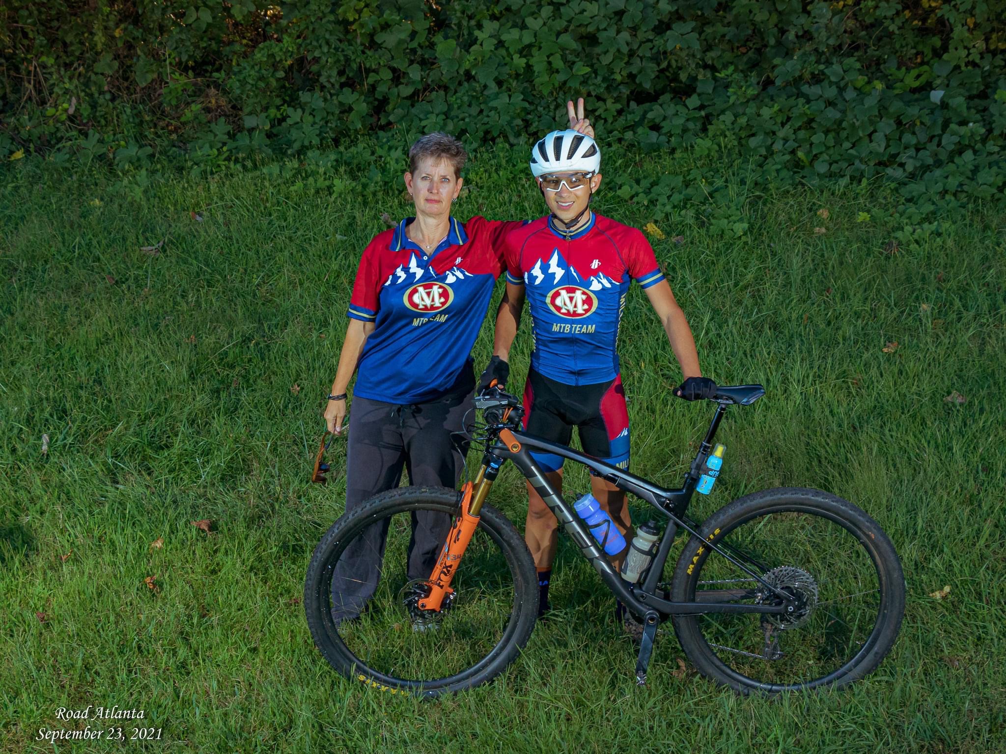 Douglas with a teammate and mountain bikes