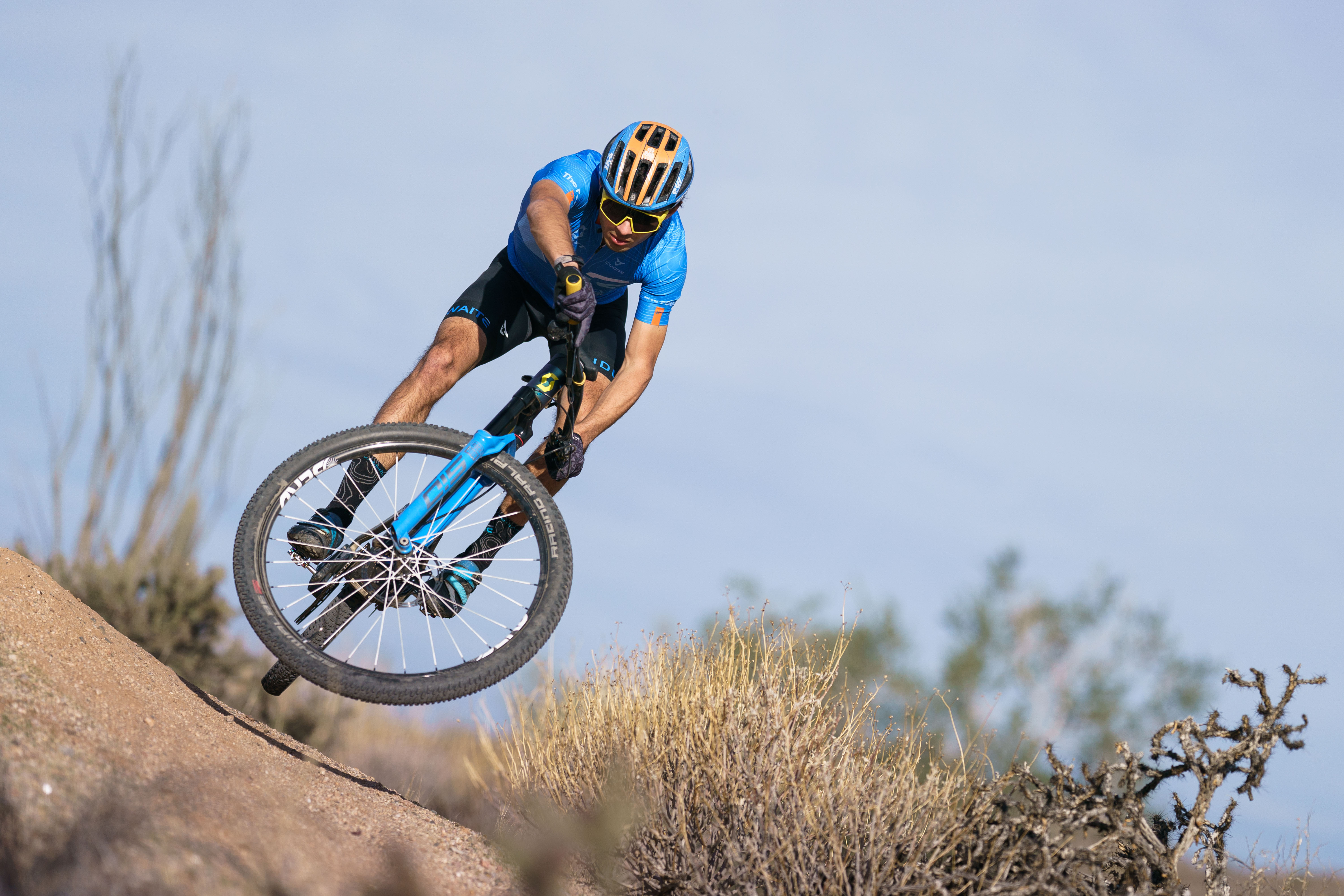 Douglas Gambarota airborne during a cross-country mountain bike race